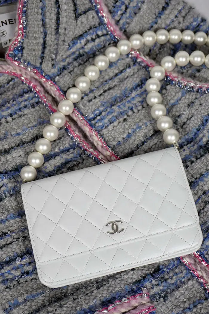 Bolso Chanel "Wallet On Chain" en piel de cordero azul-gris, artículo de segunda mano, combinado con una Chaqueta Chanel Tweed