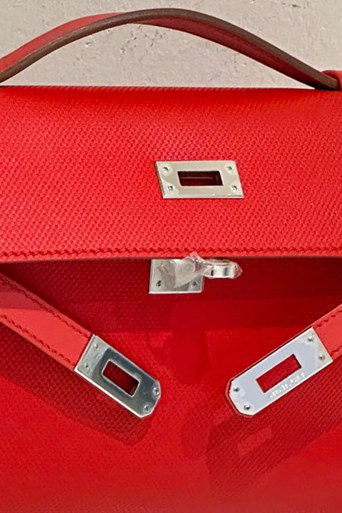 Kelly in Red Casaque leather, zoom on the palladium closure