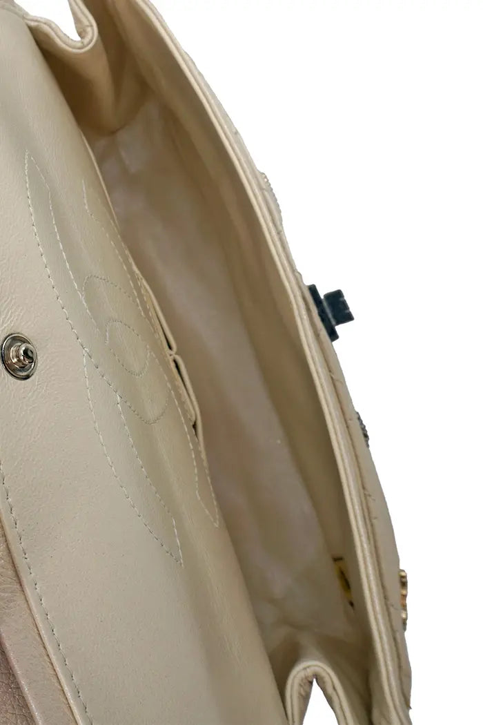 Inside Chanel 2.55 mini bag, open flap, main compartment visible.