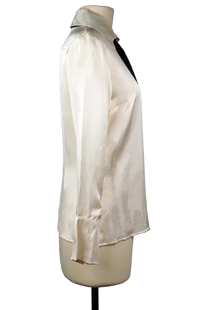 Side view of Chanel's cream silk shirt, fluid cut