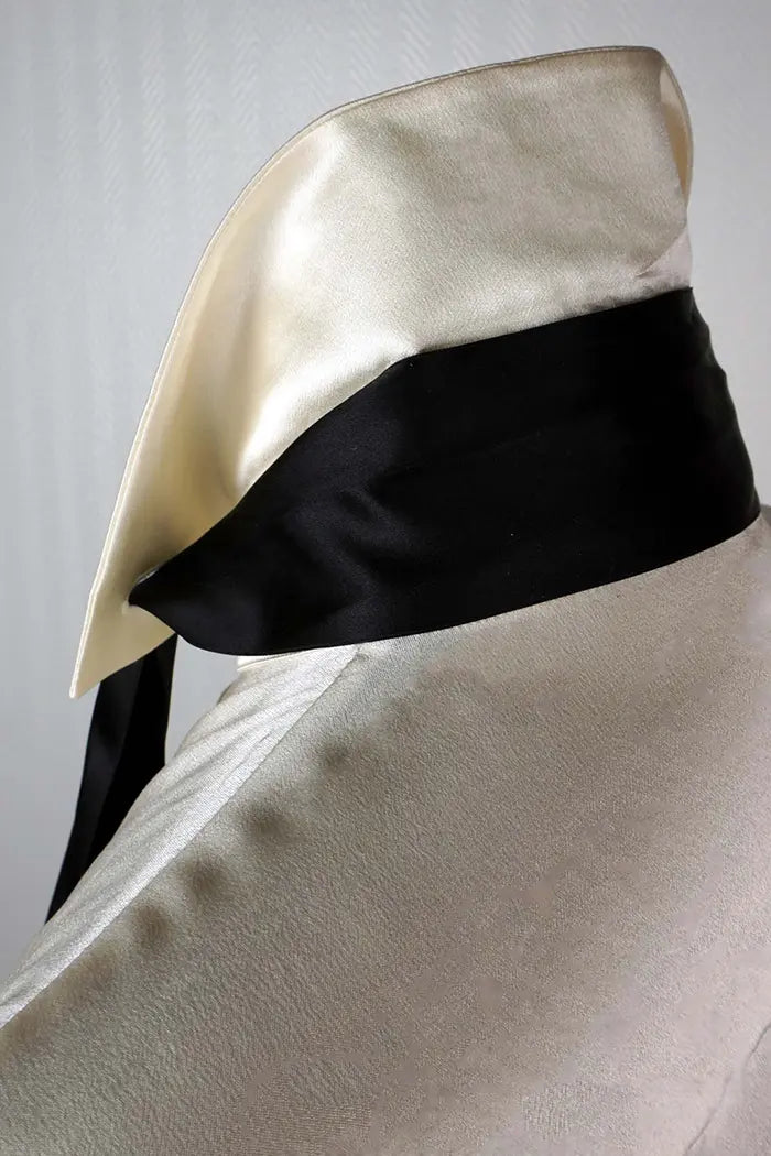 Close-up of the collar with detachable black tie on the cream Chanel blouse.