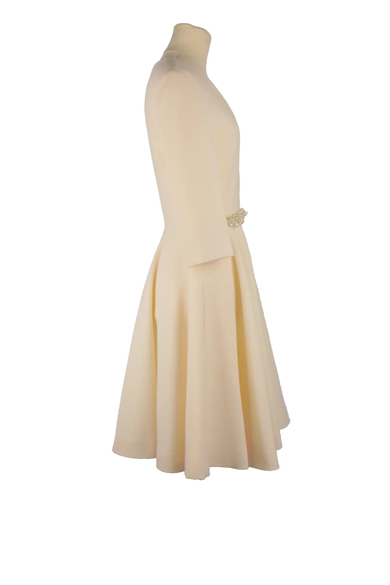 Straight profile of Lanvin's ivory wool and silk dress on mannequin, 3/4 sleeves and V-neck, elegant silhouette with subtle beaded details.