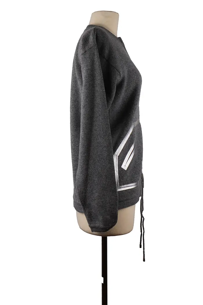 Right side view of the Chanel Spring 2016 cashmere sweater, soft drape and understated finishes, to be paired with flowing pants or a straight skirt.