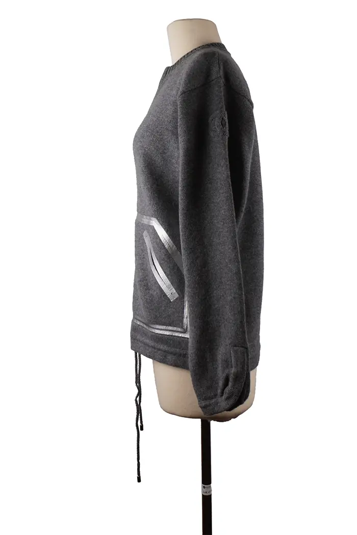 Left profile of the Chanel cashmere sweater, zip fastening and flowing silhouette, perfect for a casual chic mid-season look.