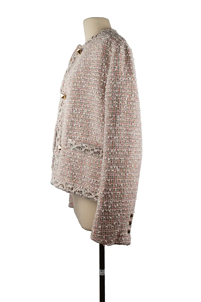 Left profile of Valentino jacket in textured bouclé fabric, elegant cut with discreet sheen and Rockstud details visible from the side.