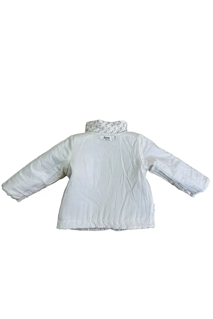 Intérieur de la veste Bonpoint matelassée, doublure blanche unie avec col contrastant imprimé, taille 2 ans.