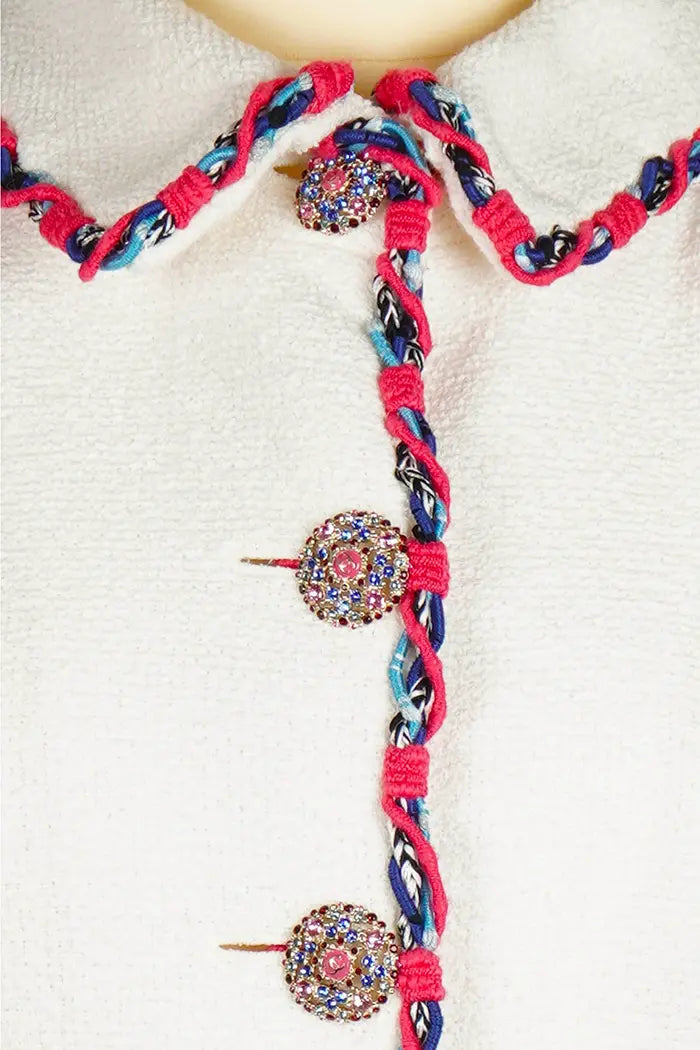 Close-up of the work around the collar and buttons of the Chanel Cruise 2015 jacket. Light elegance for a refined summer.