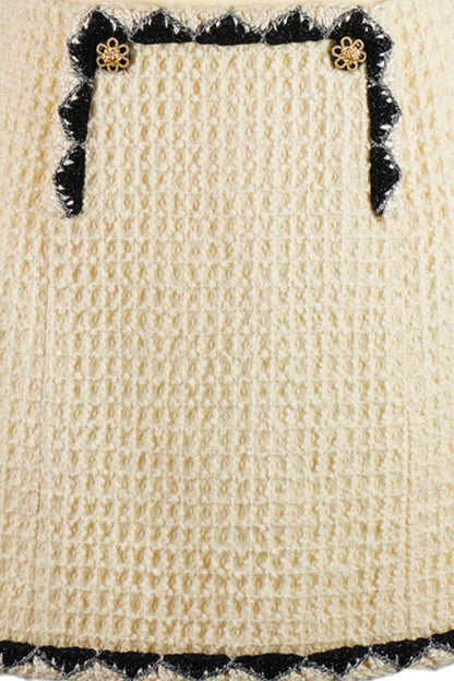 Close-up of details of Chanel, two buttons and black embroidery on skirt. Reference 1000023. Reench, preloved.