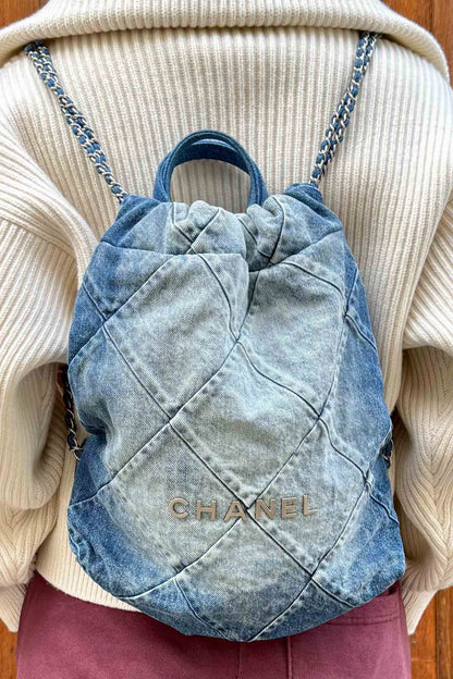 Chanel 22 Backpack in Denim, ref. 1000036, worn on the back by a Reench model. Preloved luxury.