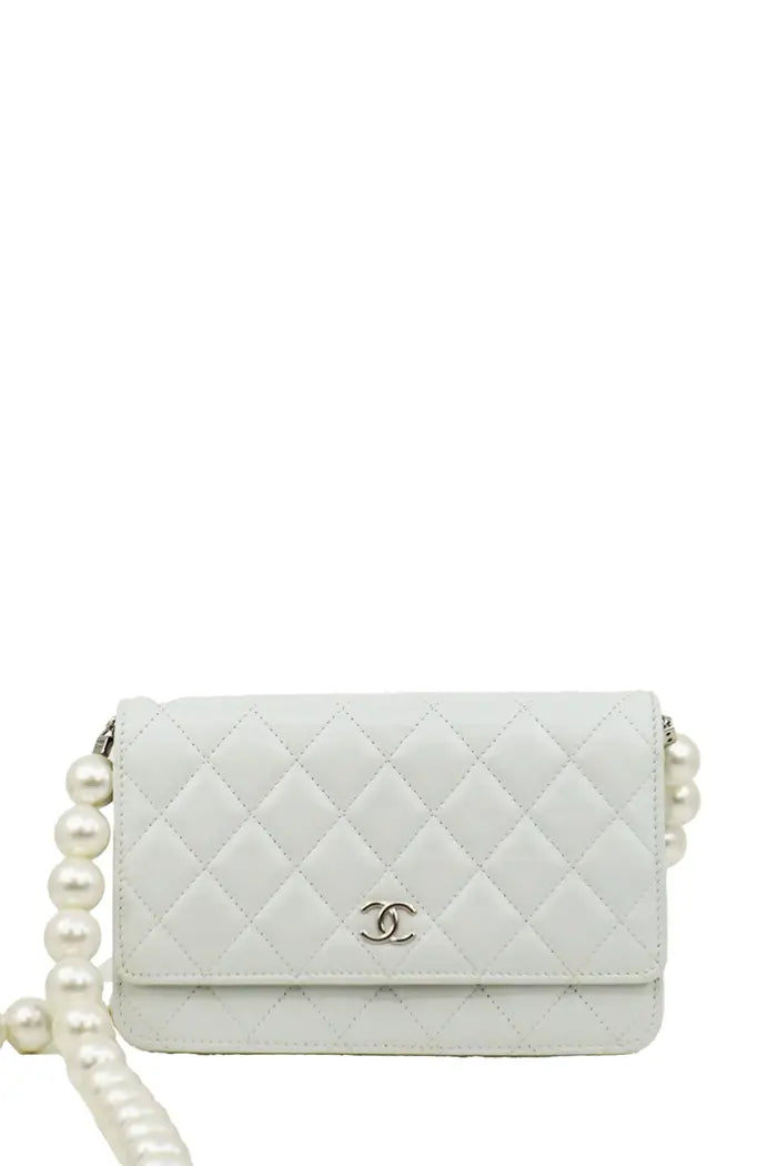 Chanel Wallet on Chain bag in blue-gray lambskin, compact size with discreet CC logo, elegant and feminine piece.