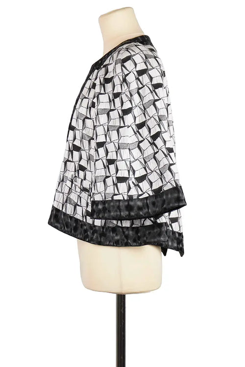 Chaqueta Chanel de algodón blanco y negro, artículo de segunda mano, vista lateral