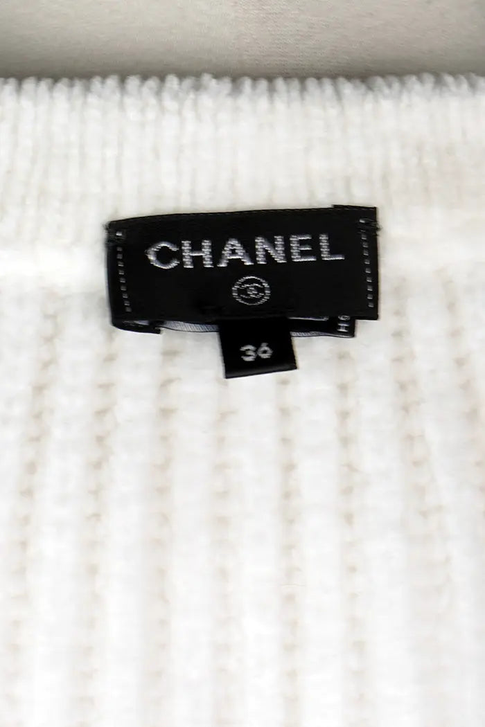 Cardigan Chanel blanc, collection Automne/Hiver 2022, article d'occasion, zoom sur l'étiquette Chanel