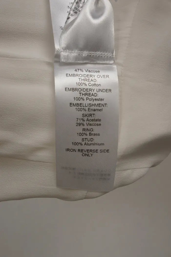 Vestido blanca Chloé de largo medio, artículo de segunda mano, zoom en la etiqueta de composición