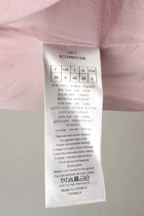 Vestido Christian Dior rosa empolvado con mangas 3/4, artículo de segunda mano, zoom en la etiqueta de composición