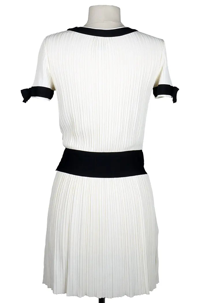 Vestido Chanel color crema con detalles y lazos negros, prenda de segunda mano, vista posterior