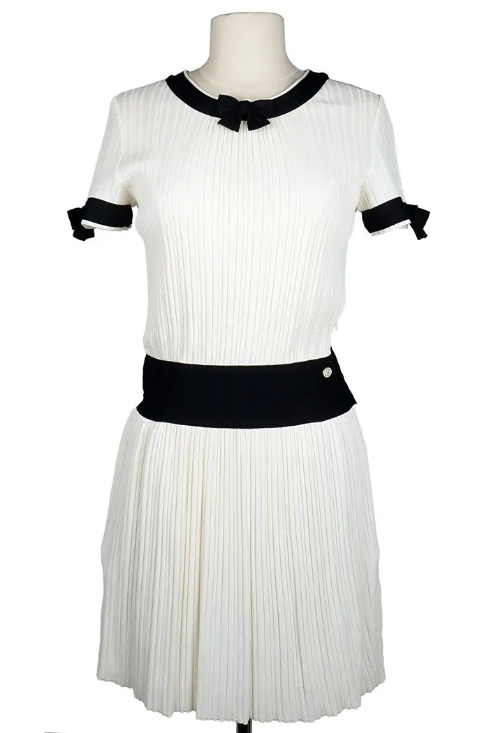 Chanel cream mini-dress with black accents and bow ties, pre-owned item, front view