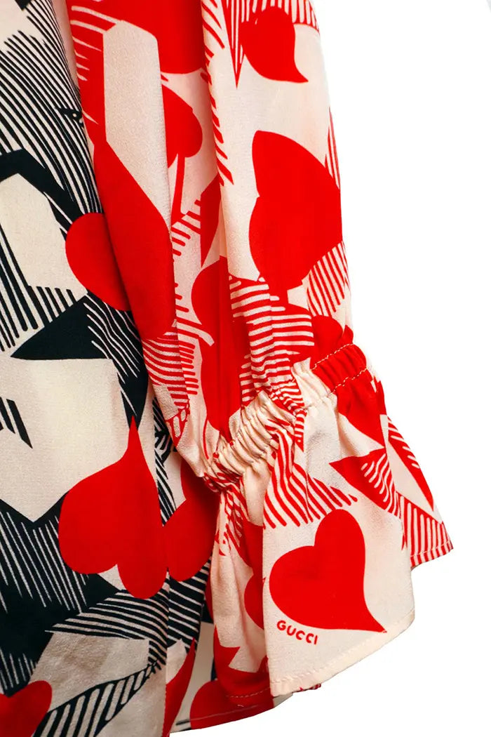 Blusa suelta Gucci en seda con corazones rojos y negros entrelazados, prenda de segunda mano, zoom en manga y puño