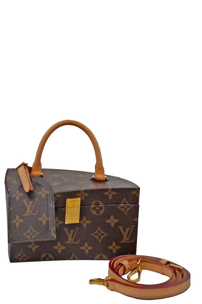 Side view of the Twisted Box bag by Frank Gehry in Louis Vuitton Monogram canvas with rounded handle and removable leather shoulder strap.