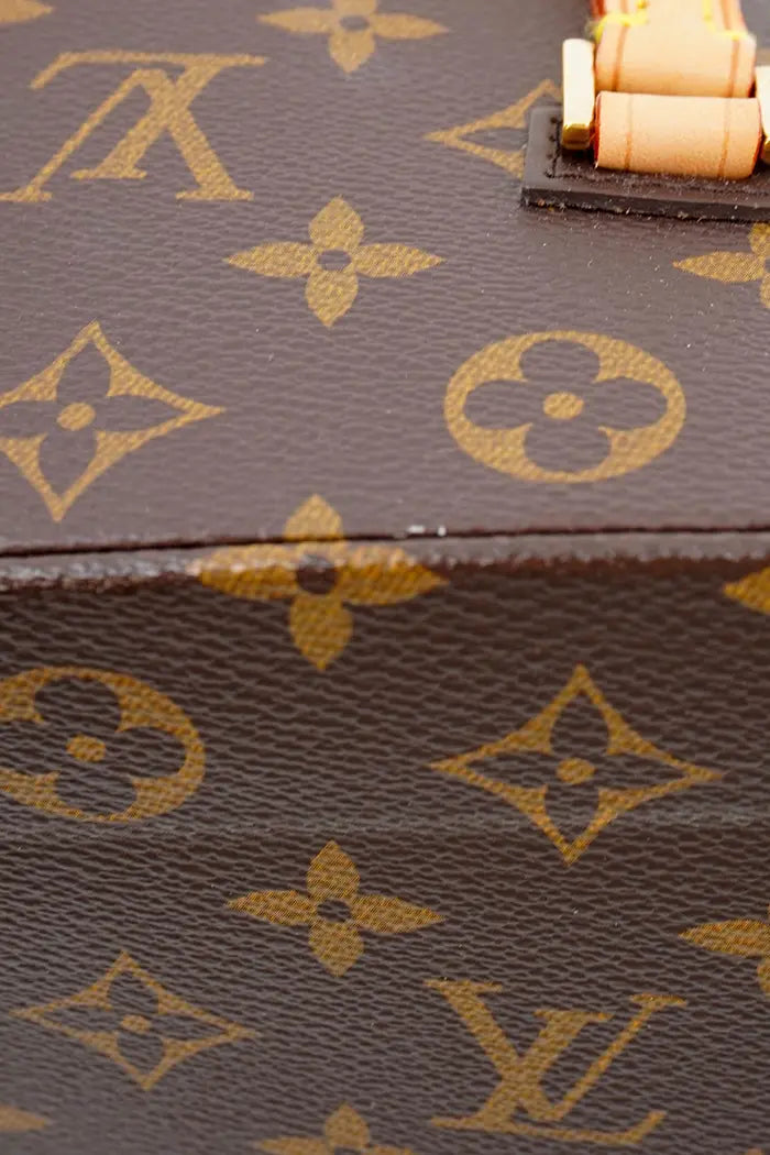 Close-up of a slight trace of wear on the Monogram canvas of Louis Vuitton's preloved Twisted Box bag.