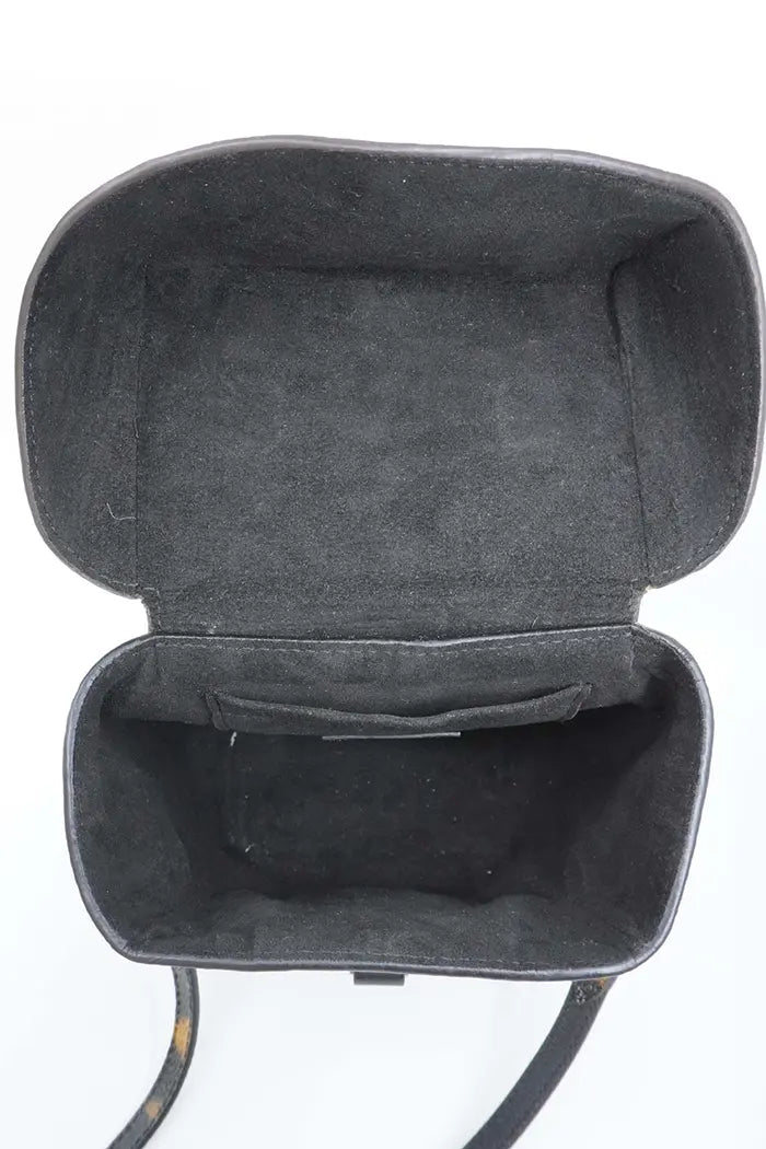 Interior of Louis Vuitton preloved Camera Box bag with black microfiber lining and patch pocket.