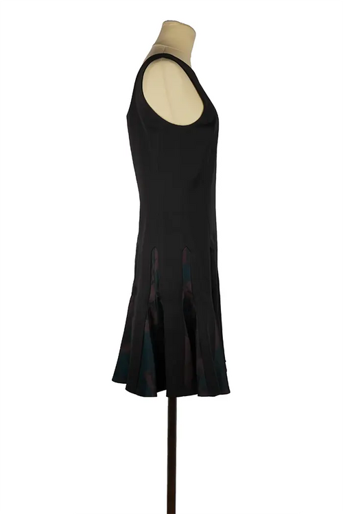 Christian Dior short dress in wool and satin silk on mannequin, structured black top and refined printed skirt, ideal for an elegant evening look.