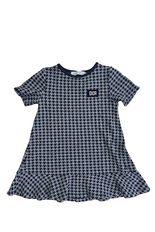 Baby Dior girl's dress, front view, navy blue and gray houndstooth pattern with embroidered DIOR logo on chest.