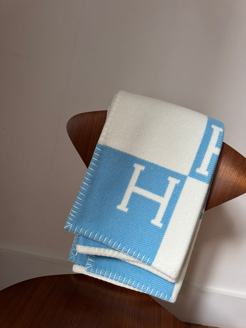 Couverture Hermès Avalon pour bébé Preloved posée élégamment sur une chaise